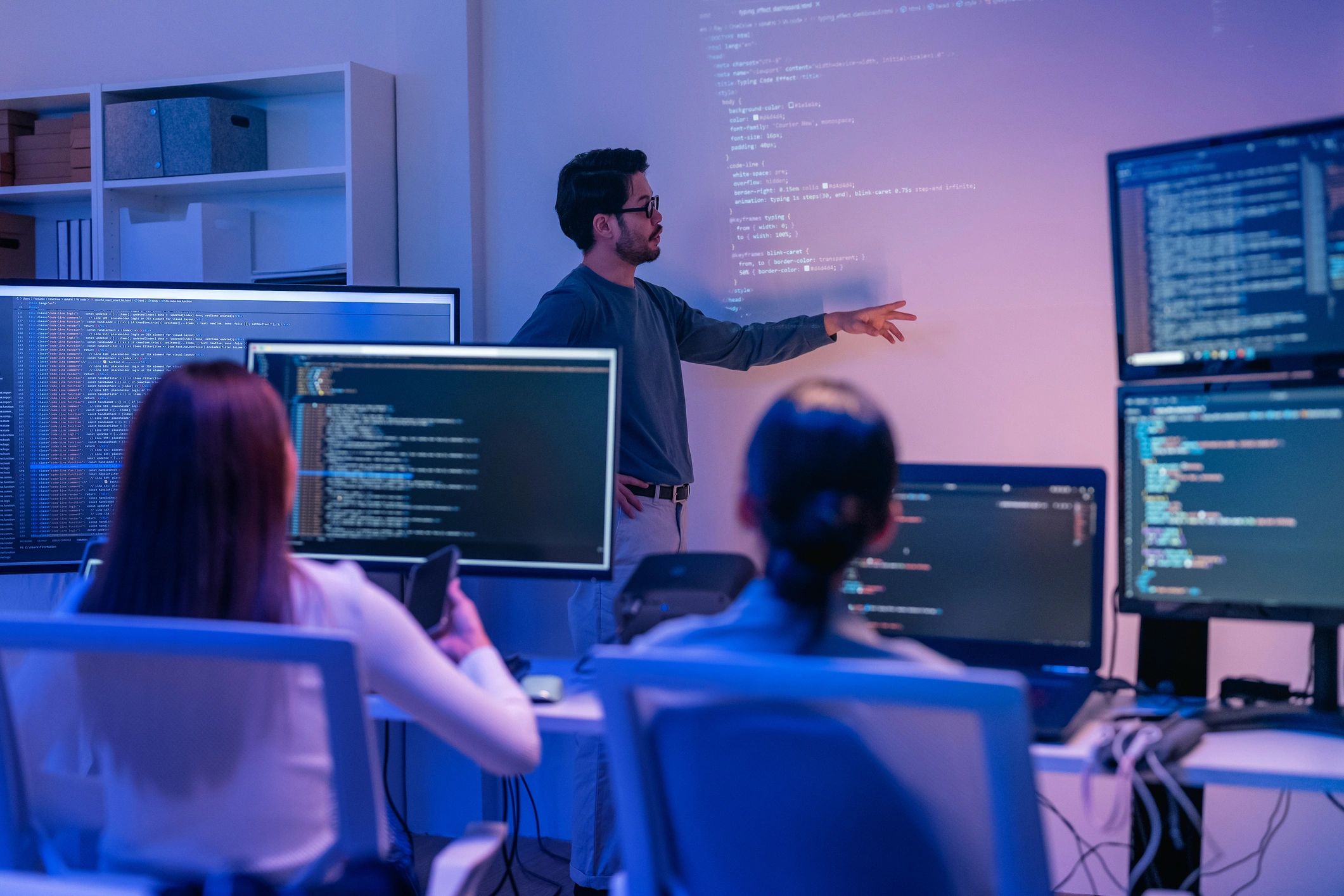 young Asian software development manager leads a late-night